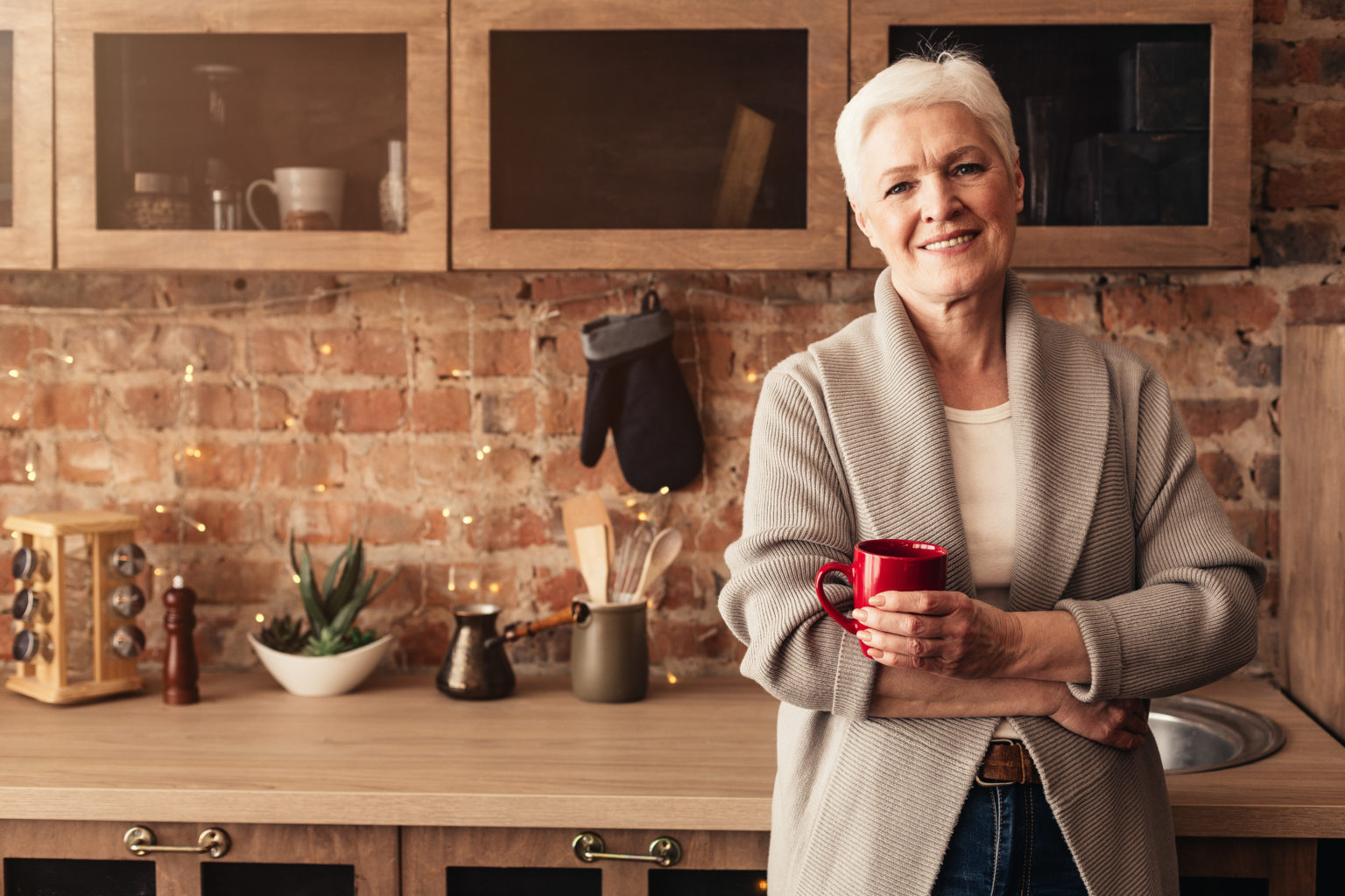 Happy Elderly Woman Standing In Kitchen With Cup Of Coffee Mammaprint Et Blueprint